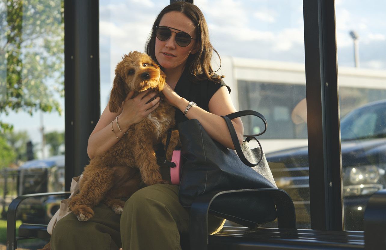 The Essex Tote on a shoulder at a bus stop, Penny in arm