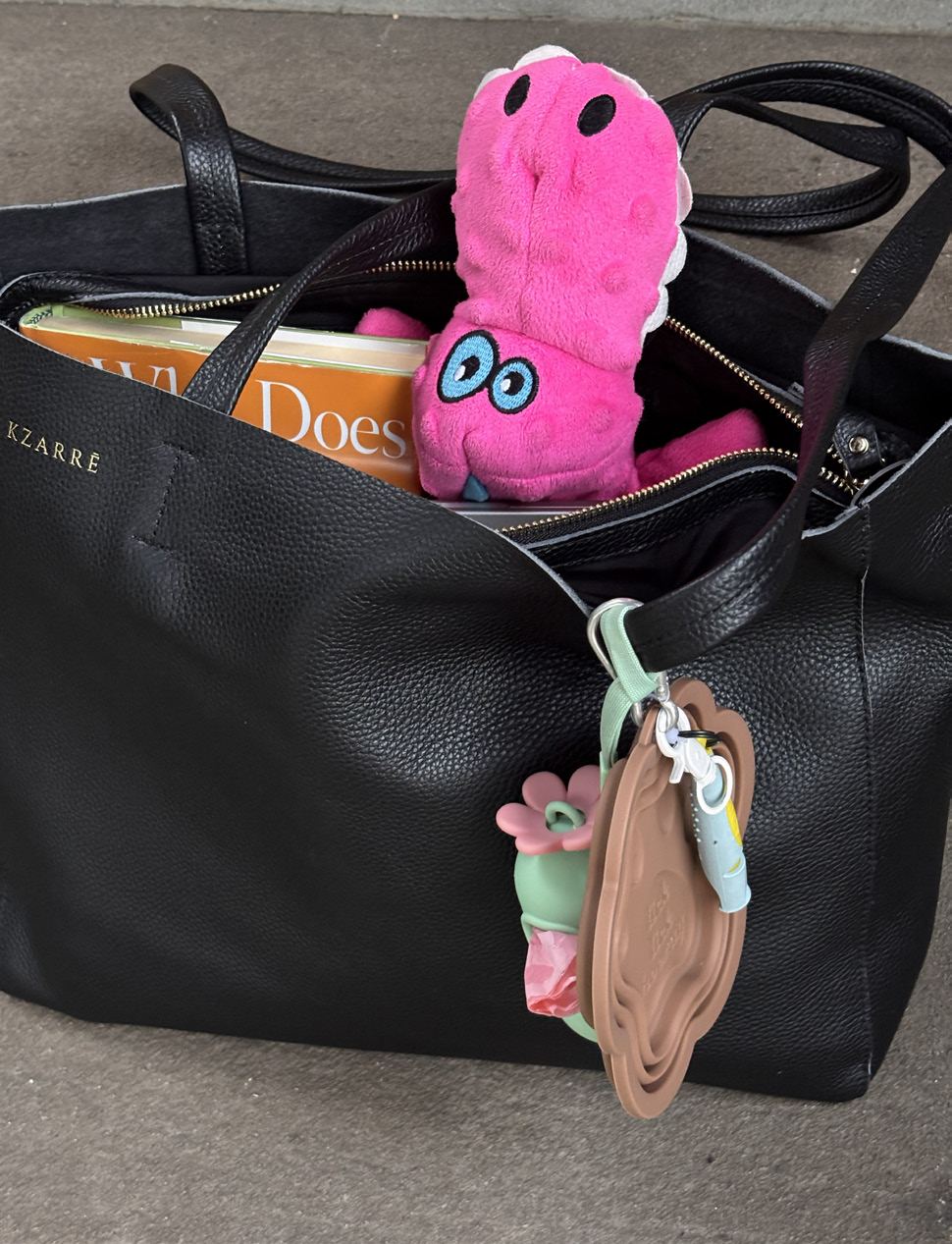 Inside the Essex Tote — full-grain leather, a book, a toy